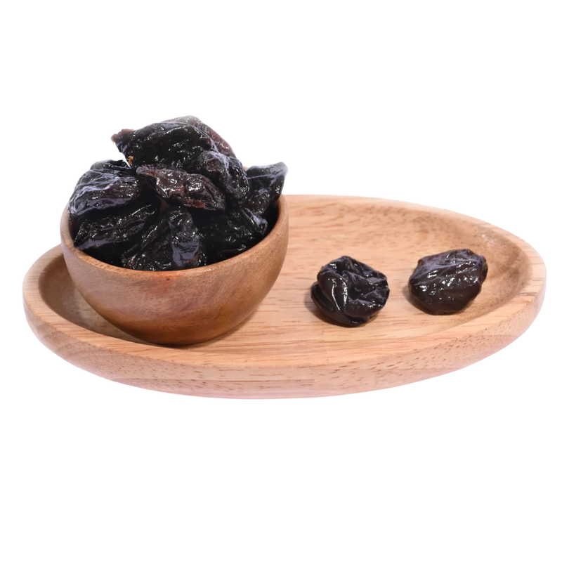 Pitted Prunes Dried displayed in a wooden bowl emphasizing premium quality and natural freshness.
