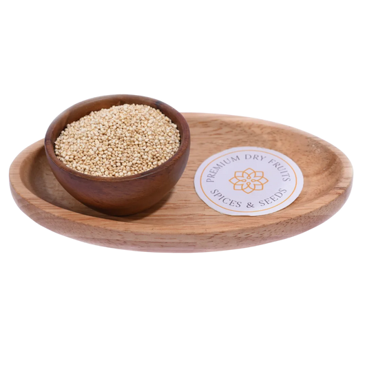 Small, round Quinoa White Seeds in a wooden bowl, showcasing their pale cream color and natural texture.