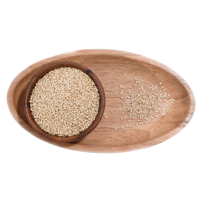 Fresh Quinoa White Seeds in a wooden bowl, showing their smooth surface and natural off-white hue.