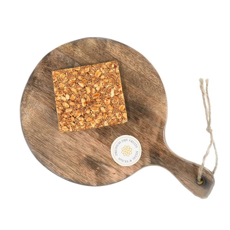 Rajgira Peanut Chikki on wooden plate delicious Indian jaggery brittle with rajgira and peanuts nutritious crunchy snack ideal for festivals and vrat season
