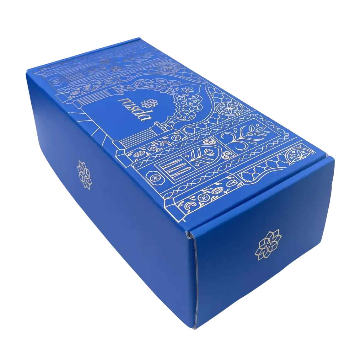Blue decorative box with intricate white patterns on a white background