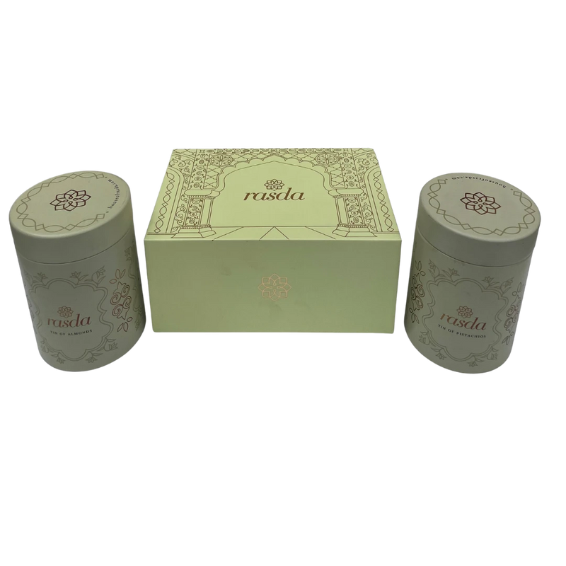 Two cylindrical green containers with a matching box featuring Rasika Dry fruits Gift Box with Tins Rasda branding on a white background.
