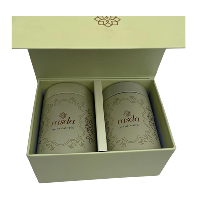 Two cans of 'rasda' in a green box on a white background - Rasika Dry fruits Gift Box with Tins