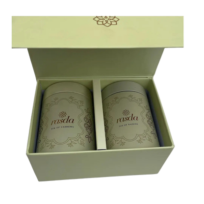 Two cylindrical containers Rasika Dry fruits Gift Box with Tins  rasda branding in a green box on a white background