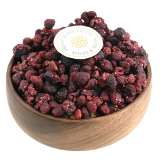 Premium raspberries dried in a wooden bowl, showcasing their deep red color and natural texture.