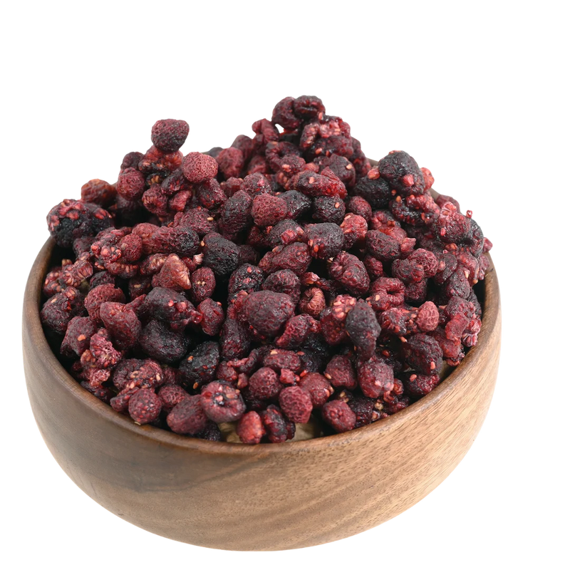 Naturally raspberries dried displayed in a rustic wooden bowl, highlighting their vibrant color and premium quality.