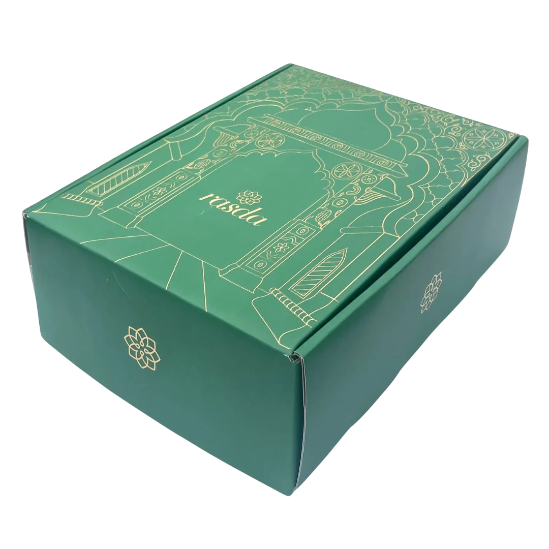 Premium Rashmika tin opened to reveal a colorful assortment of nuts and dry fruits, presented in a luxury gift box.