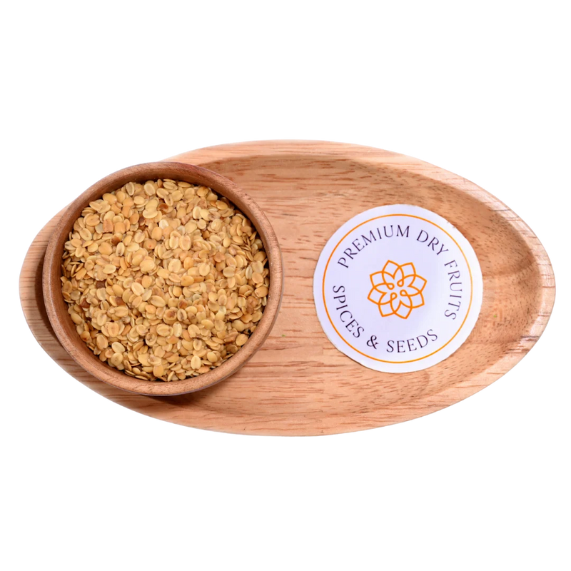 Premium Roasted Coriander Seeds or Dhana Dal displayed in a rustic wooden bowl, showcasing their golden roasted texture.