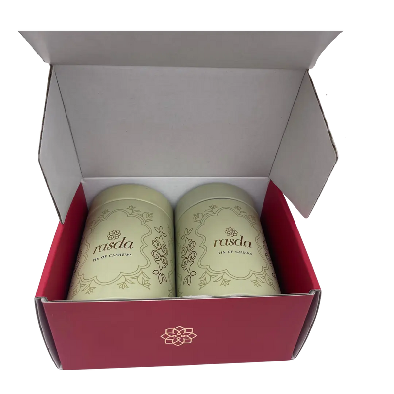 Two green containers with a brand logo in a red box on a white background- Rudira Dry fruits Gift Box Premium with Tins inside.