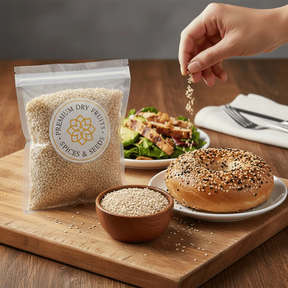 Package with white sesame seeds, bowl of seeds on a wooden board.