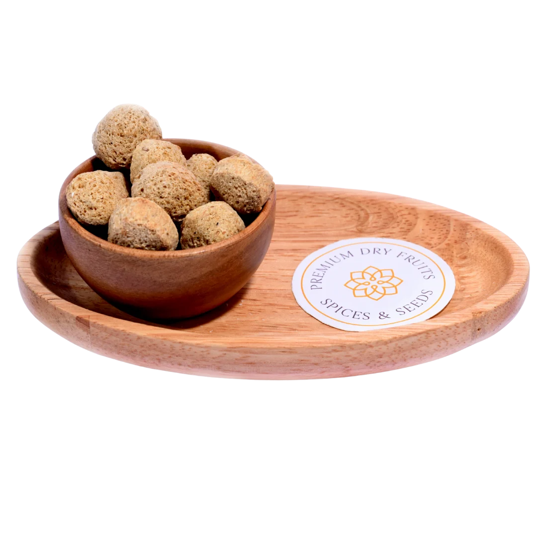 Light brown Soya Chunks in a wooden bowl, showcasing their round, spongy texture and protein-rich quality.