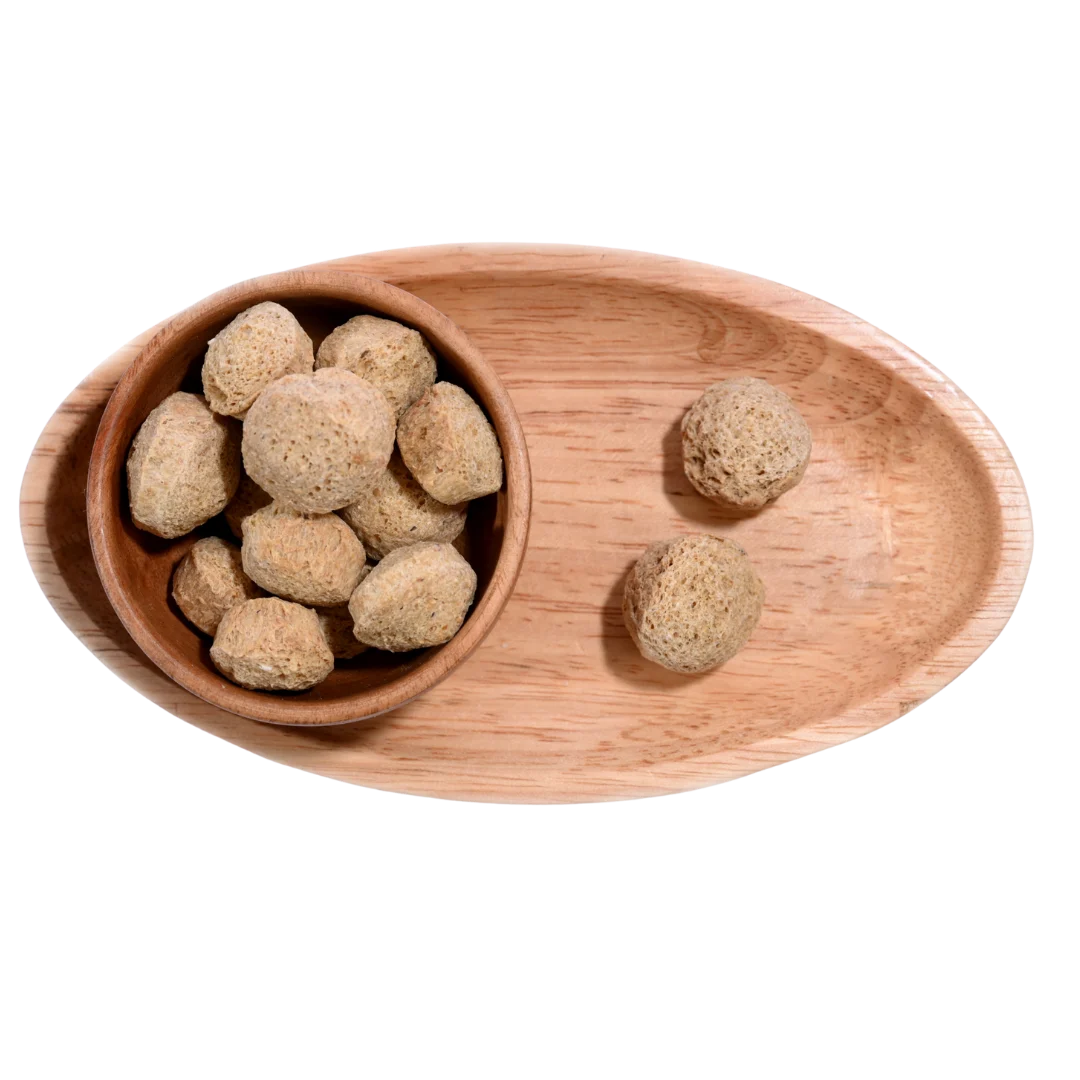 Dried Soya Chunks arranged in a wooden bowl, showing their firm texture and nutritional value.