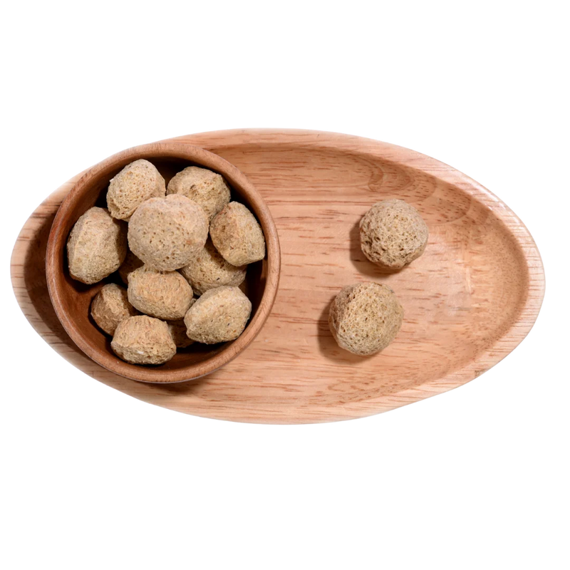 Dried Soya Chunks arranged in a wooden bowl, showing their firm texture and nutritional value.