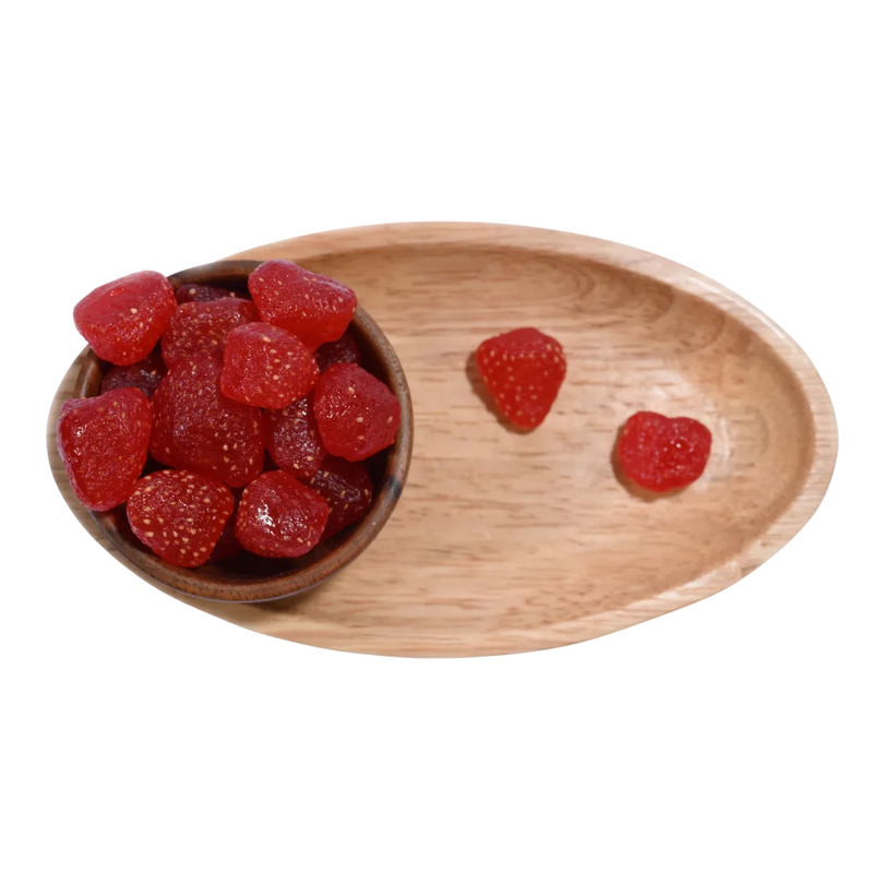 Wooden bowl and tray with red Strawberries Dried Whole Premium on a white background.