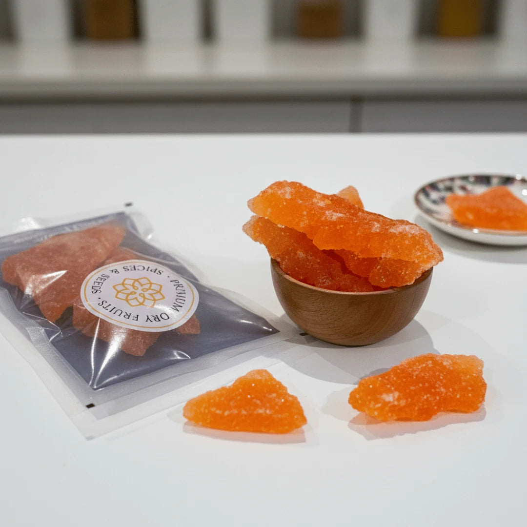 Orange crystallized Sugar Candy in a bowl and on a table with a branded package.