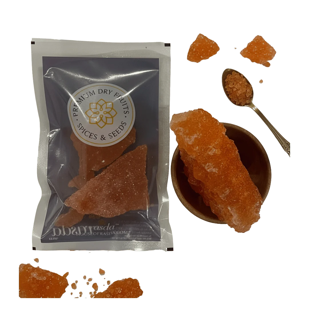 Packaged Sugar Candy with a bowl of Laal Mishri and a spoon on a white background