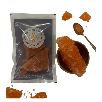 Packaged Sugar Candy with a bowl of Laal Mishri and a spoon on a white background