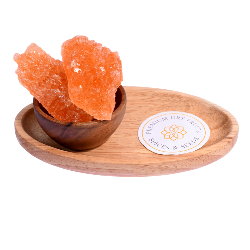 Traditional red Laal Mishri or sugar candy crystals in a wooden bowl – rich color, perfect for pooja and prasad offerings.