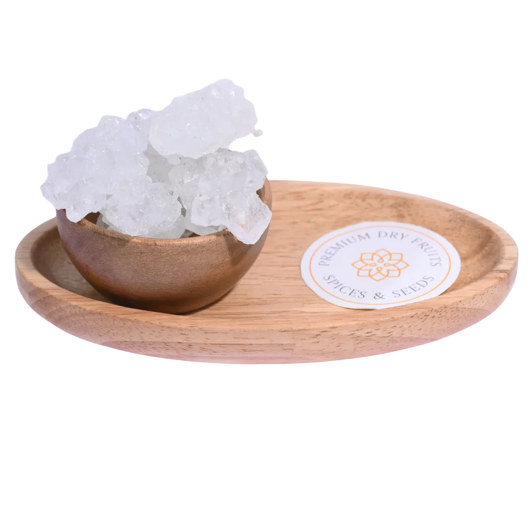 Thread Crystal or Dhaaga Mishri in a wooden bowl showcases long, translucent sugar crystals.