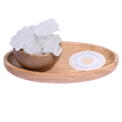 Thread Crystal or Dhaaga Mishri in a wooden bowl showcases long, translucent sugar crystals.