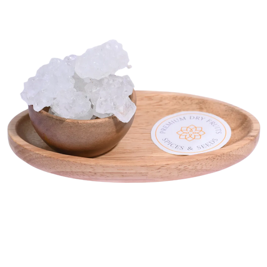 Thread Crystal or Dhaaga Mishri in a wooden bowl showcases long, translucent sugar crystals.