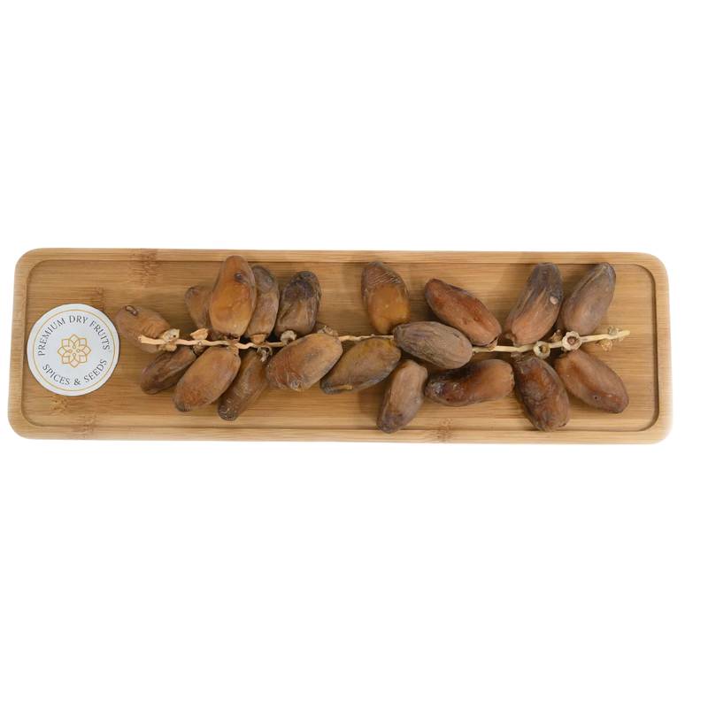 Premium Deglet Noor Dates Tunisia with branches on wooden tray – natural sweet dry fruit