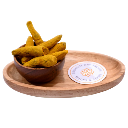 Turmeric stick or haldi gatiya in wooden bowl natural spice for cooking and health