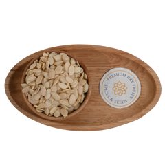 Top view of healthy watermelon seeds neatly arranged in a round wooden bowl.