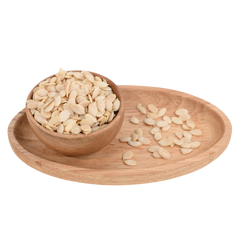 Tarbuj Magaj, or watermelon seeds, served in a natural wooden bowl, perfect for snacking.