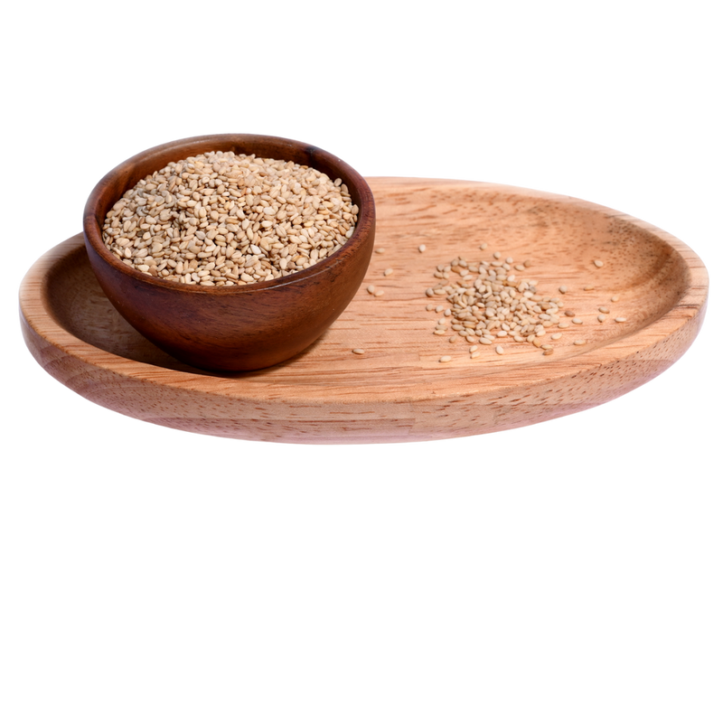 Close-up of small, oval-shaped white sesame seeds, scattered across a smooth surface.