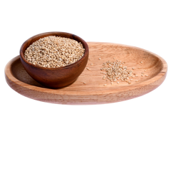Close-up of small, oval-shaped white sesame seeds, scattered across a smooth surface.
