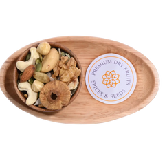 Wooden bowl with Wholesome Nutty Trail Mix assorted dry fruits and spices on a wooden tray.