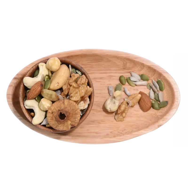 Wooden tray with Wholesome Nutty Trail Mix various nuts and seeds on a white background