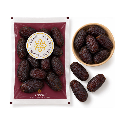 Medjool dates in a 250g pouch beside a wooden bowl of the dates, with loose dates on a white background
