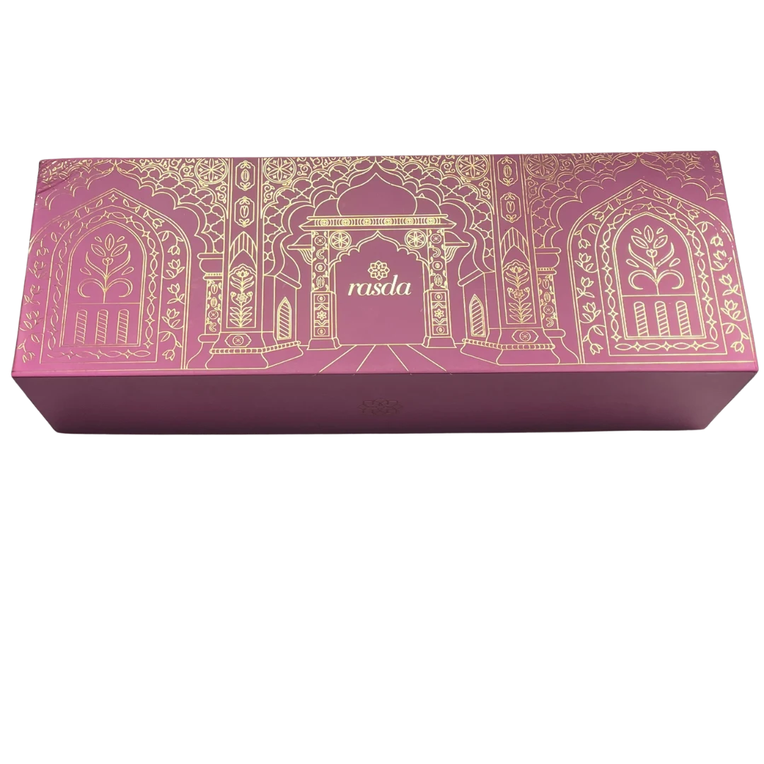 Ratnagarbha Signature gift box closed, rose pink rigid box with gold-foiled arch detail and the rasda wordmark