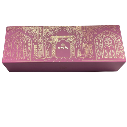 Ratnagarbha Signature gift box closed, rose pink rigid box with gold-foiled arch detail and the rasda wordmark