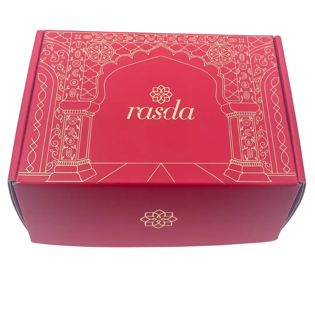 Ruchi Designer gift box closed, crimson pink with gold Mughal archway line art and the rasda wordmark