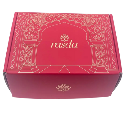 Ruchi Designer gift box closed, crimson pink with gold Mughal archway line art and the rasda wordmark