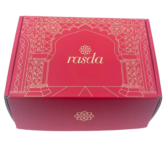 Ruchi Designer gift box closed, crimson pink with gold Mughal archway line art and the rasda wordmark