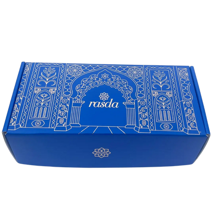 Rucira Designer gift box closed, cobalt blue with white Mughal archway line art and the rasda wordmark